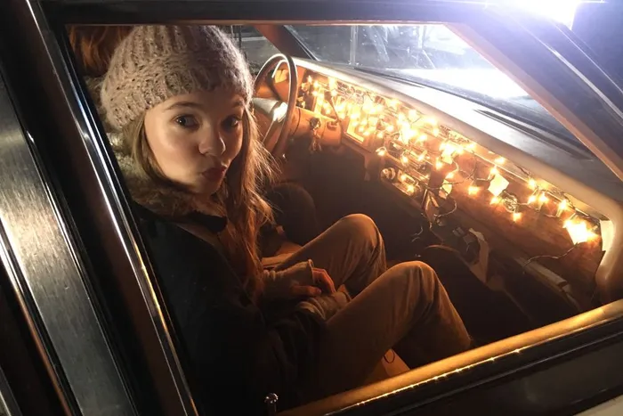 Beautiful Taylor Hickson is lit for the night driving shot with simple Xmas lights taped to the dash.
