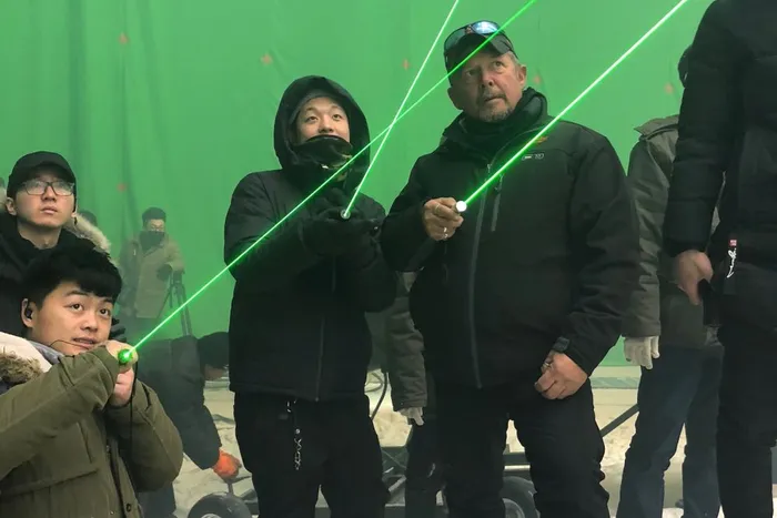 No, not a Star Wars battle. Gaffer Rory Soderman instructs his crew on lighting placement.