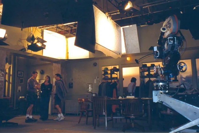 Setting up soft bounce reflectors for a studio scene.