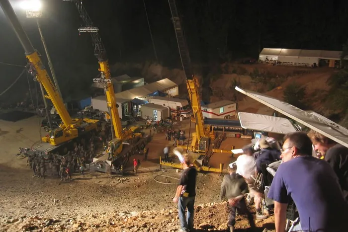 Industrial cranes for rain and lighting above the night battlefield.