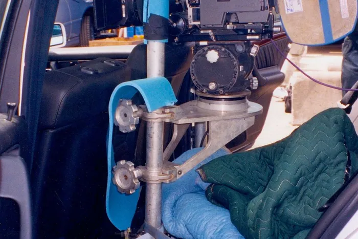 Inside a stunt car, the grips have secured a camera mount.