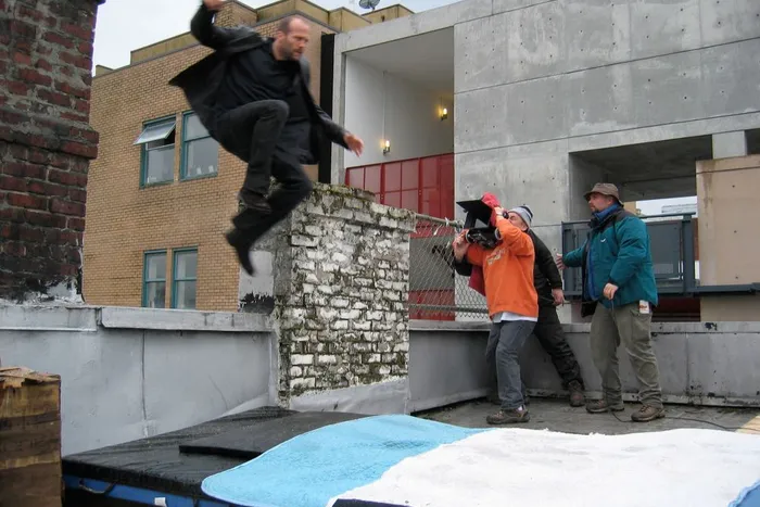 Hong Kong action master Corey Yuen captures Jason Statham on camera.